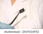 Electronic chip, bug in scientist's hand, Highlighting advancements in medical technology and neuroscience research, cognitive enhancement, neural implants, Neurotechnology Advancements