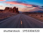 Middle of the Road View of a Scenic route in the desert. Colorful Sunrise Sky Art Render. Taken on Route 24, Utah, United States of America.