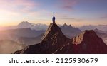 Adventurous Man Hiker Standing on top of a rocky mountain overlooking the dramatic landscape at sunset. 3d rendering peak. Background image from British Columbia, Canada. Adventure Concept Artwork