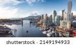 Small photo of Panoramic Aerial View of Granville Island in False Creek with modern city skyline and mountains in background. Downtown Vancouver, British Columbia, Canada.