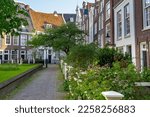 Small photo of AMSTERDAM, NETHERLANDS - MAY 5, 2013: This is the courtyard of the medieval Begijnhof, a former closed community of beguines, located in the city center.