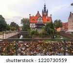Small photo of GDANSK, POLAND - SEPTEMBER 2, 2018: View of many love locks at the Love Bridge and Miller's House at the Mill Island in Gdansk's Old Town in Poland. St. Cathrine's Church is in the background.
