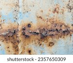 Small photo of "The old train caboose, weathered by time and corroded by rust, has developed a captivating blend of patterns and a beautiful, intriguing surface."