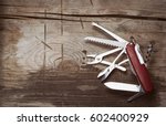 Old swiss knife on a wooden...