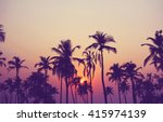 Silhouette of palm trees at...