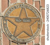 Small photo of Fort Worth, Texas - November 4, 2023: texas trail of fame honors Tad Lucas with a plate at walk of fame in Fort Worth Stockyards.