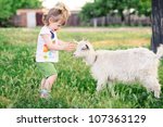 A Little Girl With A Goat