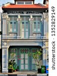 Small photo of Singapore - March 11th 2019: Front view of traditional Singapore Straits Chinese or Peranakan shop house entrance and 1st floor with strong architectural detail and colours in historic Joo Chiat