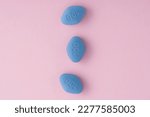 Small photo of Blue pills viagra on pink background. Top view. Medicine concept of medication for potency, erection, treatment of erectile dysfunction, pulmonary hypertension