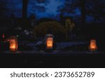Small photo of Votive candles lantern burning on the graves in Slovak cemetery at night time. All Saints' Day. Solemnity of All Saints. Hallows eve. 1st November. Feast of Saints. Hallowmas. Souls' Day in Slovakia