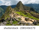 Small photo of Machu Picchu ruins with tourists with dramatic clouds, Machu Picchu historical Sanctuary, Cusco, Peru.