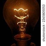 Small photo of Magnifying View of Incandescent Light Bulb.Explore the intricate beauty of an incandescent light bulb like never before with this captivating magnified view.