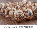 Small photo of Quail eggs on the wooden plate. Quail eggs can be consumed by frying or boiling. In Indonesia quail eggs called telur puyuh.
