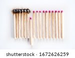 Burnt matches and whole matches on white background. The spread of fire. One whole match isolated to stop the fire. Stop destruction concept