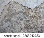 Small photo of Unbalanced cemented wall. Holes on the construction wall. Rough surface of aged wall