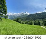 Small photo of cable cars in the alps with mountain range background and alpine views of the valley bellow and above the tree line