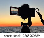 Sony camera in action, recording the breathtaking orange hues of a sunset. 
