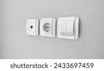 Small photo of Double light switch, Socket, and Antenna Socket for TV socket on gray wall