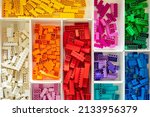 Small photo of Khabarovsk, Russia, February 25, 2022. Top view many multicolored Lego Classic details sorting by colors closeup. Bright plastic constructor pieces neatly accommodation in box container for storage