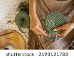 Small photo of Closeup female hands knitting interior decor basket use green ribbon yarn and crochet needle. Creative woman arms enjoying needlecraft hobby or art work making comfortable cotton sewing accessories