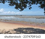 Small photo of a beach where sea water is ebbing and flowing
