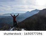 Small photo of Happy mountaineer get rest and enjoy on snowy mountain high above the clouds. Look into the sun and snow