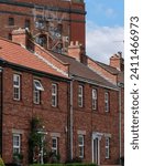 Small photo of Red brick terraced houses in front of a red brick bonded warehouse in Bristol