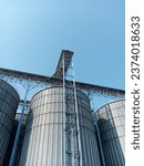 Small photo of Tanks and agricultural silos of grain elevator storage. Loading facility building exterior. View from below,Storage of bulk food products. Special grain silo for crop storage.