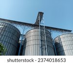 Small photo of Tanks and agricultural silos of grain elevator storage. Loading facility building exterior. View from below,Storage of bulk food products. Special grain silo for crop storage.