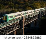 A train crossing a viaduct in southern england.