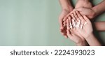 Small photo of paper family cut showing on hands, family home, foster care, homeless support, protect, health care, world mental health day, Autism support, homeschooling education, parents day concept