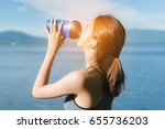 Athlete drinking protein shake nutrition,young girl asian and listen music after exercise running workout outdoor at beach seaside in summer for muscle building and slim fit body nice strong perfect. 