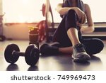Woman exercise workout in gym fitness breaking relax holding apple fruit after training sport with dumbbell and protein shake bottle healthy lifestyle bodybuilding, Athlete builder muscles lifestyle.