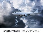 Airplane in the sky with thunder and lightning,The plane flies in terrible thunderstorm,Concept of climate weather