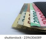 Small photo of rupiah money in the wallet with White baground,banknote. IDR 100.000. IDR 20.000. IDR 10.000 IDR 5000,2000