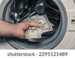 Small photo of American dollars being put into the washing machine, Concept, Money laundering, Illegal business proceeds, Dark business, Black market, Bundle of 100 dollar bills