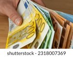 Bundles of euro money, bundle of banknotes held in a hand, Financial concept, Euro zone, Currency of the European Union