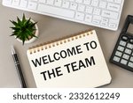 Small photo of Welcome to the team, Welcome lettering on the desk, Business concept, Building community in the company, Beautiful gray background, office equipment and a notebook with a slogan