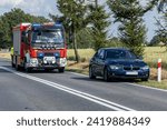 Small photo of 29.06.23 Poland. Road accident. Fire trucks and undercover police car with emergency lights block the road