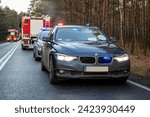 Small photo of 18.12.20 Poland. Road accident. on a forest road. A police car and a undercover police car with emergency lights