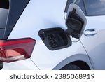 Small photo of Type 2 CCS plug port on electric vehicle. DC - CCS type 2 EV charging connector at EV car. Fast charging socket type 2 combo electric car. Eco friendly alternative energy green environment concept.