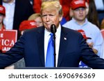 Small photo of WILKES-BARRE, PA - AUGUST 2, 2018: Donald Trump President of the United States gestures somewhere between a smirk and a smile at a campaign rally.