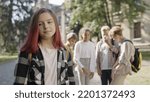Small photo of School children laughing looking at new girl, bullying, disrespect for classmate