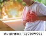 Small photo of Heart burn or Pericarditis disease concept. Man's hands on his chest suffering on chest pain, heart attack, Lung Problems, or Myocarditis. Pulmonary embolism day