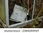 Small photo of This poignant image zooms in on the aftermath of a climate change-driven storm, revealing a fragment of a roof window from a private garden greenhouse.