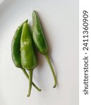 Small photo of Triplet of vibrant green chillies, a spicy and lively trio