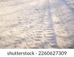 tire tracks in the snow. frozen tire tires in ice. frozen tire tracks. Car tracks on the snow at a frozen lake in Finland, aerial shot. Treads and footprints in snow, city street covered in snow.