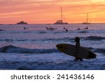 Surfers Silhouetted Against A...