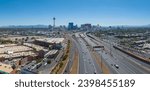 Small photo of Las Vegas, USA. May 1, 2023. Aerial view of Las Vegas, Nevada, showcasing the Stratosphere Tower, bustling hotels, casinos, clear blue skies, and surrounding mountains during a vibrant midday.