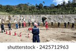 Small photo of Ulubelu, Indonesia - February 2nd, 2021: Engineers and fire extinguishers are gathering in a circle to simulate how to use fire extinguishers to extinguish fires in the field during the day.